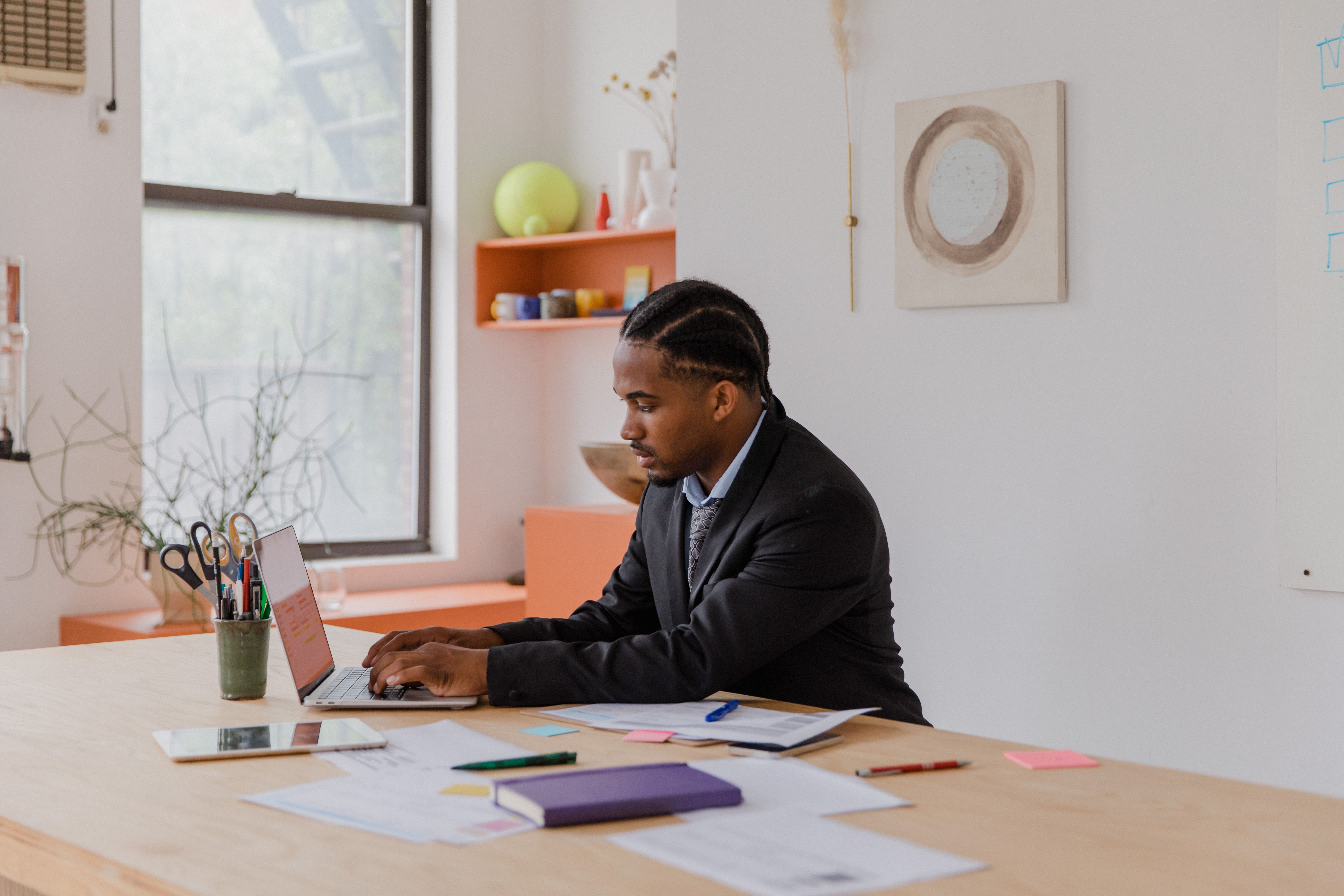 Small-business owner working on a laptop at a desk