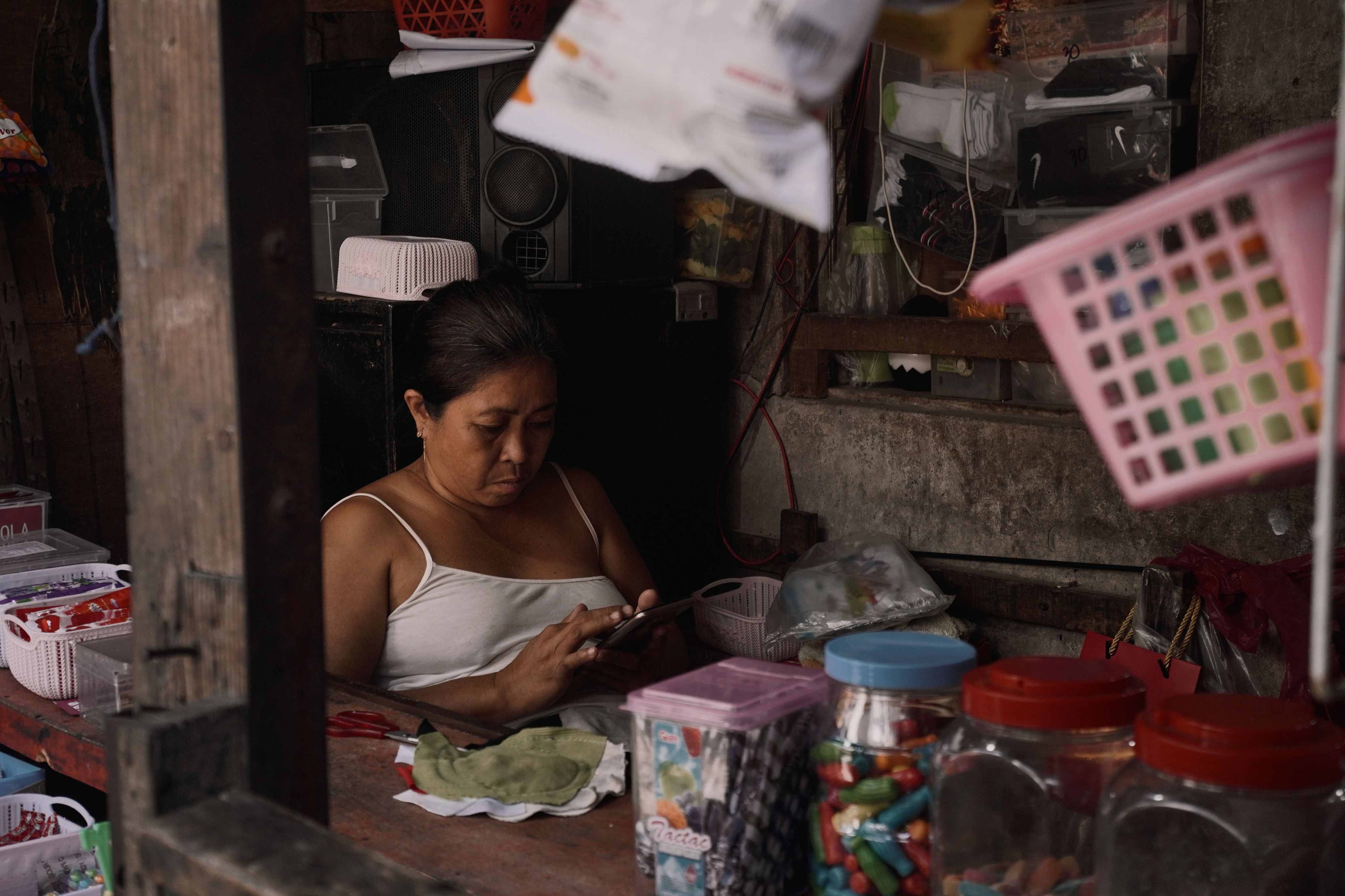 Shop owner using a smartphone inside a local store